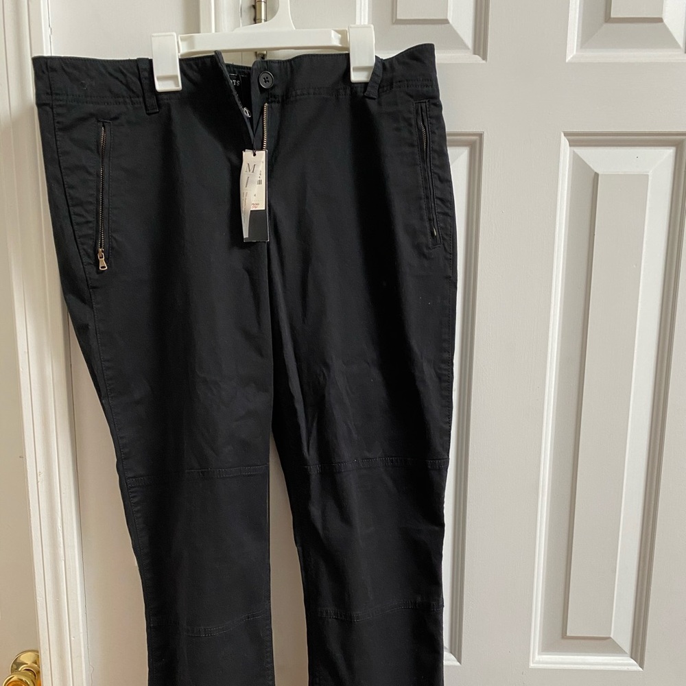 Black chino pants with zipper on pockets and ankle